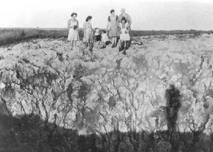 073 0084 Ein grosser Bombentrichter auf einem Feld in Petersdorf wird besichtigt